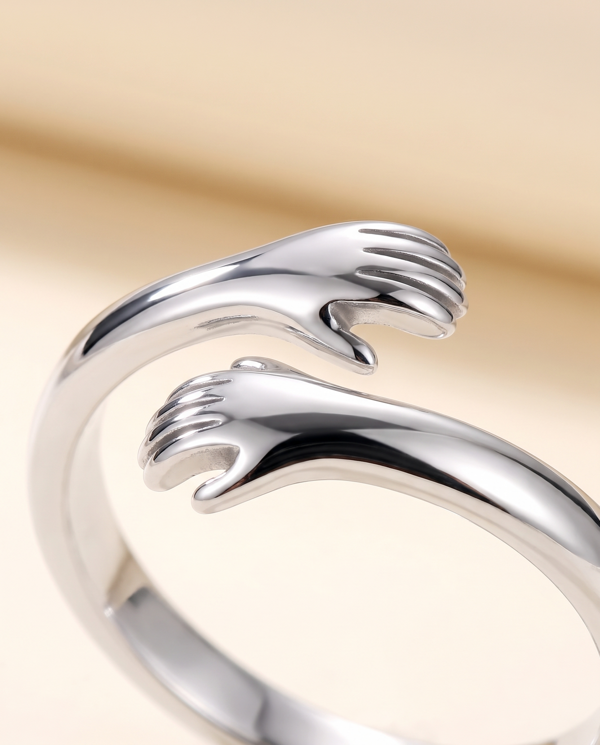 Close-up of the Hug Ring's two tiny hugging hands