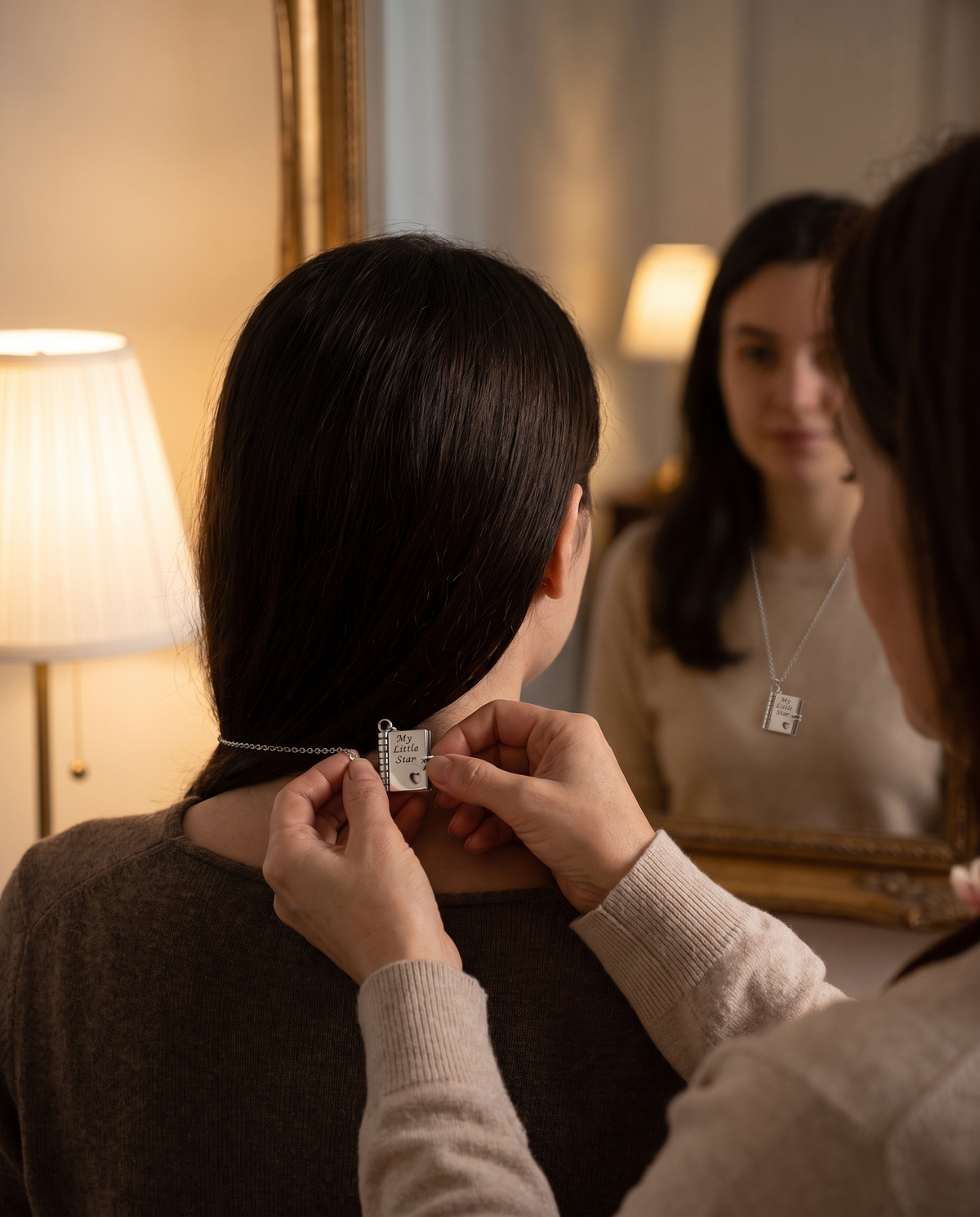 Mother fastening the My Little Star necklace on her daughter