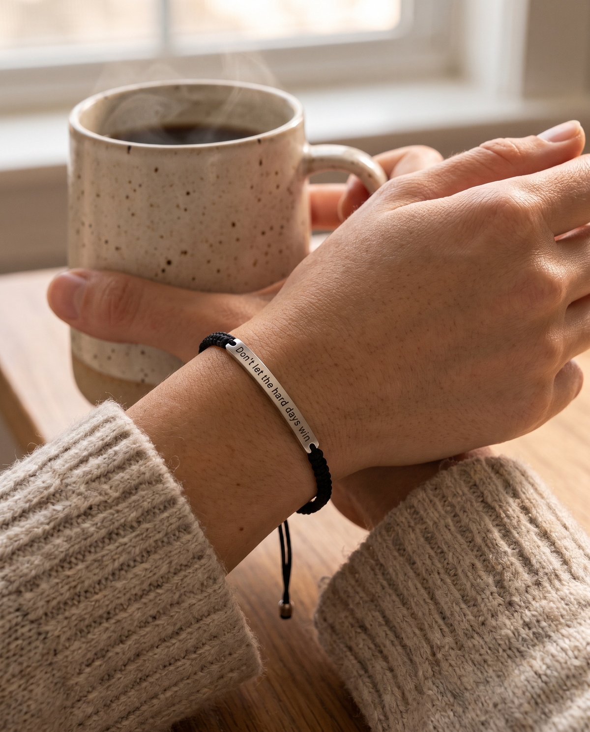 Don't Let The Hard Days Win bracelet worn on the wrist