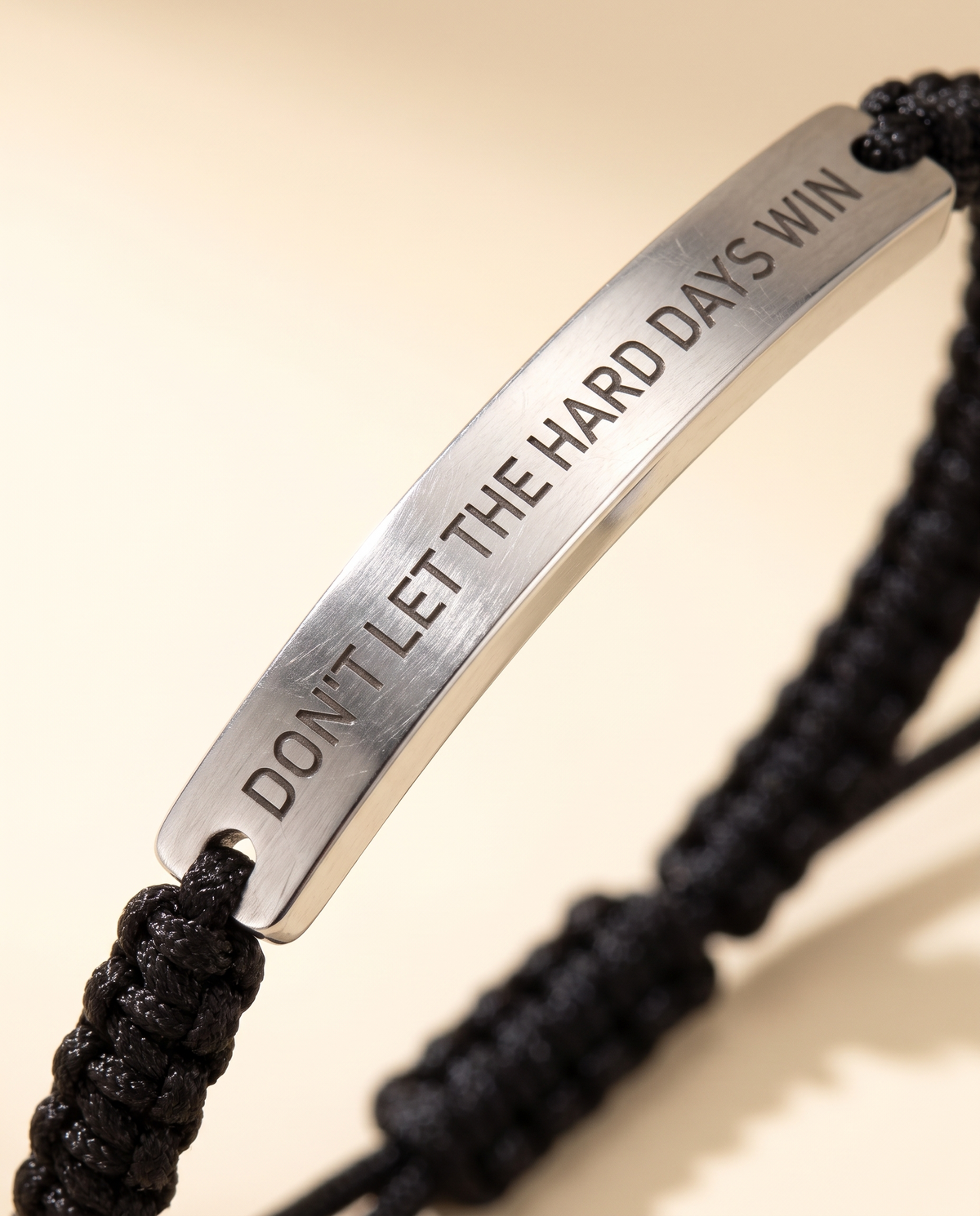 Close-up of the Don't Let The Hard Days Win engraving