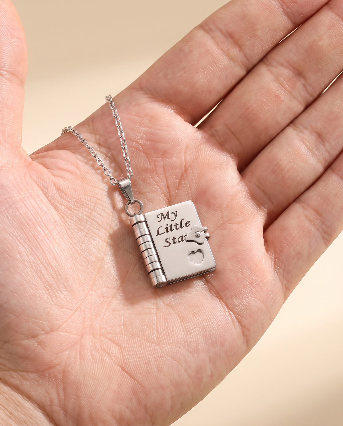 My Little Star book pendant in an open palm showing its size