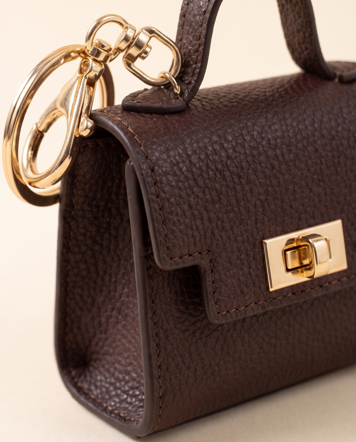 Close-up of the bag charm leather, stitching and clip