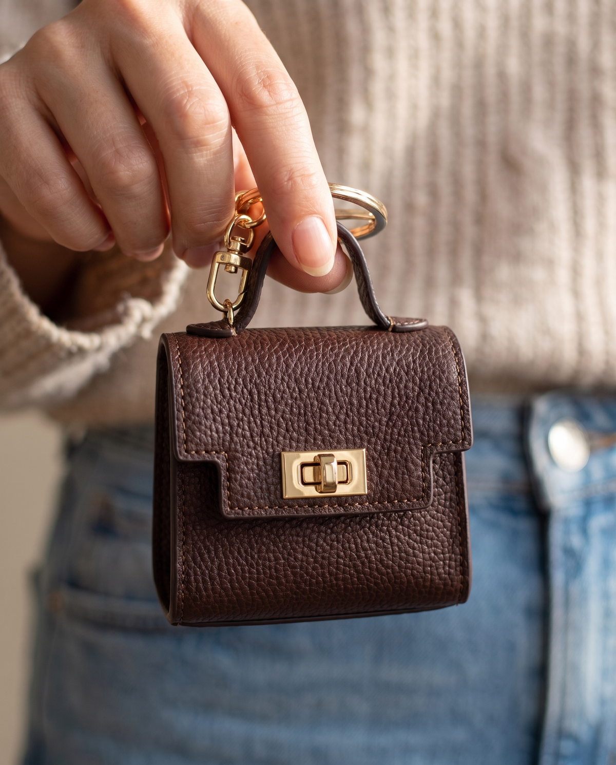 Mini bag charm held in hand showing its size