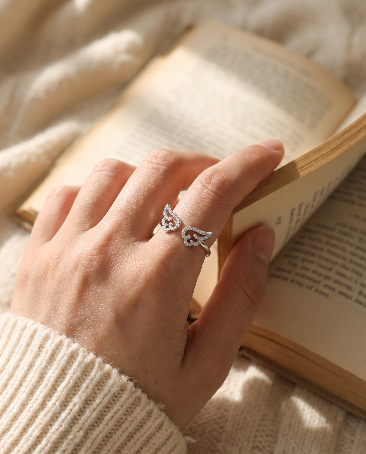 Angel Wing ring worn while reading a book